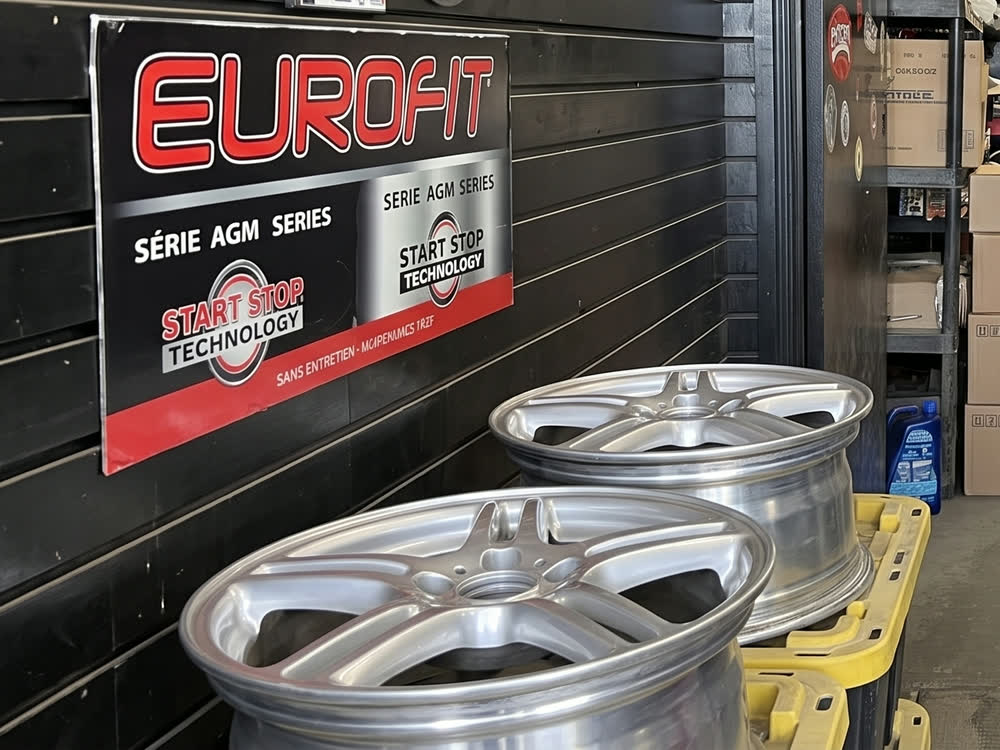 Battery boards and refinished alloy wheels by the parts wall