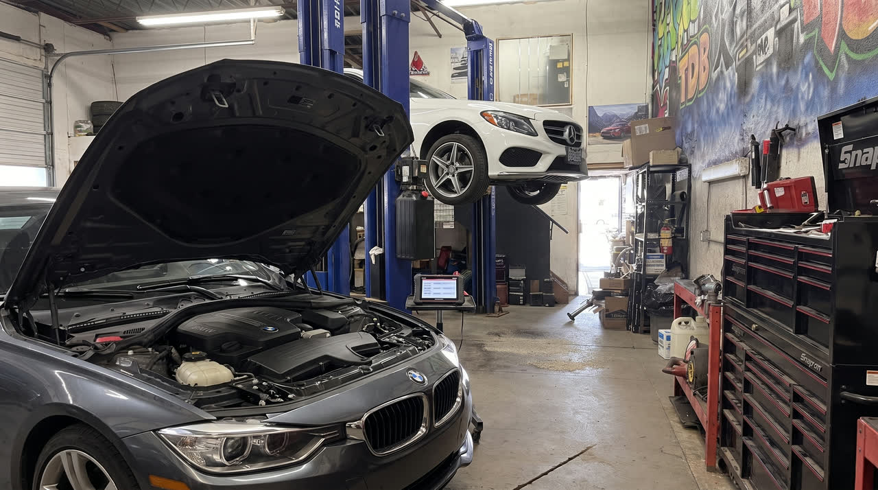 A car with the hood up in the bay for diagnosis