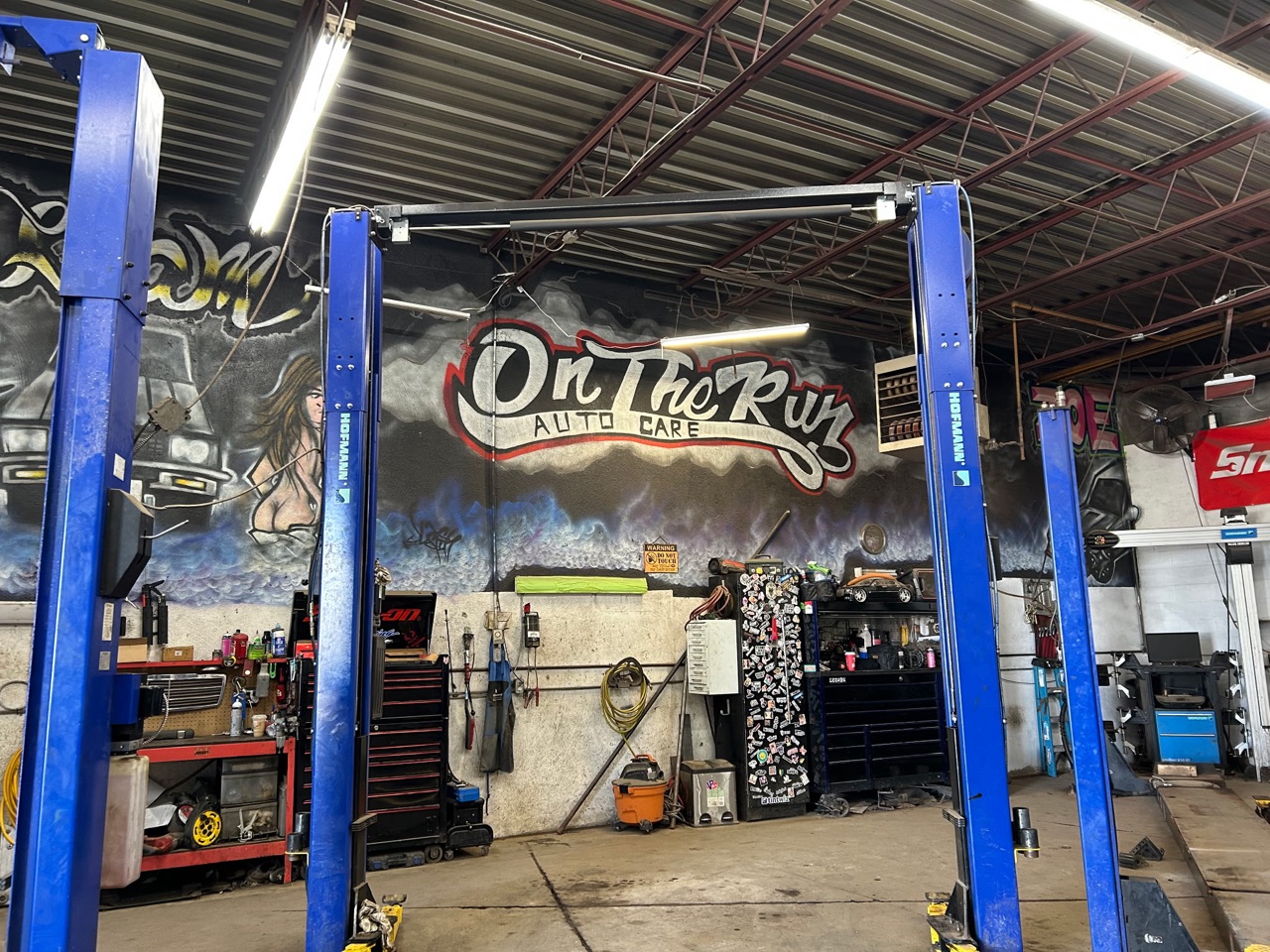 The On The Run Auto Care mural between the lifts