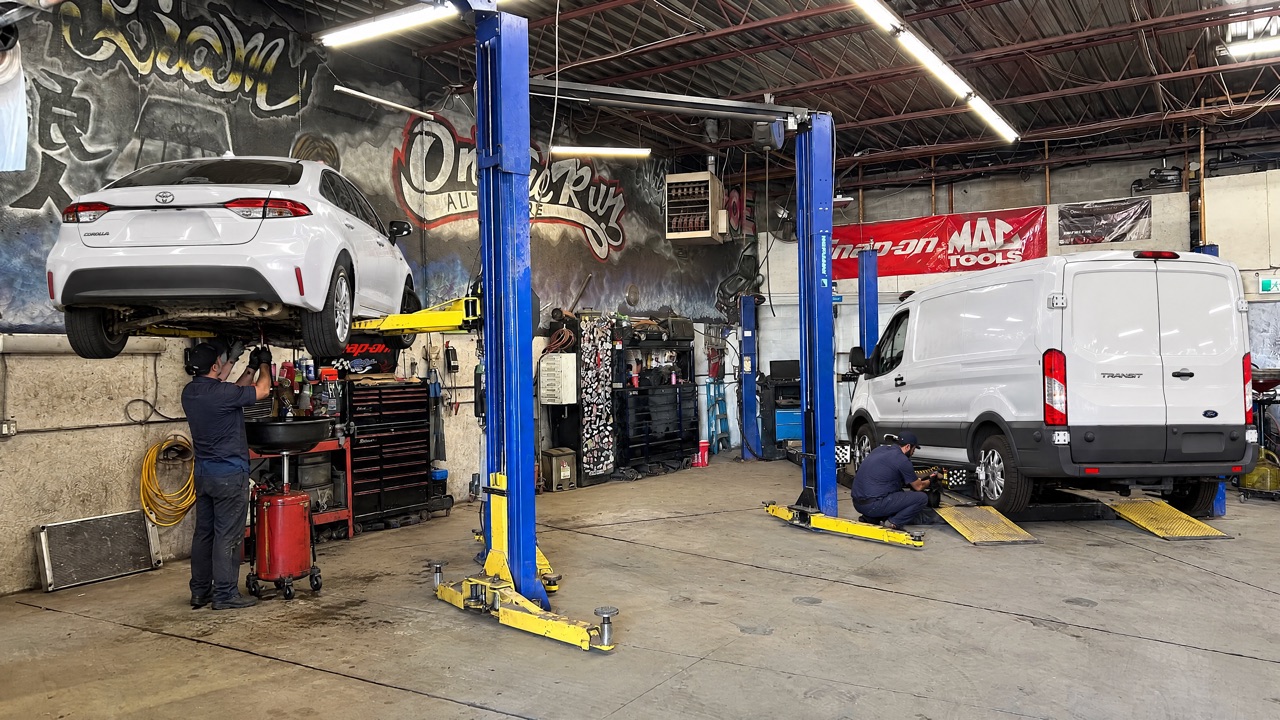An oil change on the left lift and a work van on the alignment rack